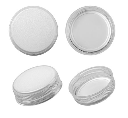 Four gray plastic bottle caps isolated on white background, showing different perspectivesの写真素材
