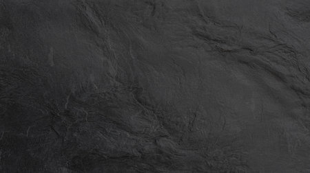 Close-up view of dark gray slate, highlighting its rough and textured surfaceの写真素材