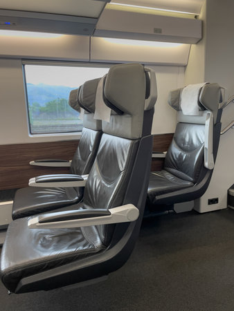 Empty leather seats inside a contemporary, high-speed train carriage, ready for passengers to embark on their journeyの写真素材