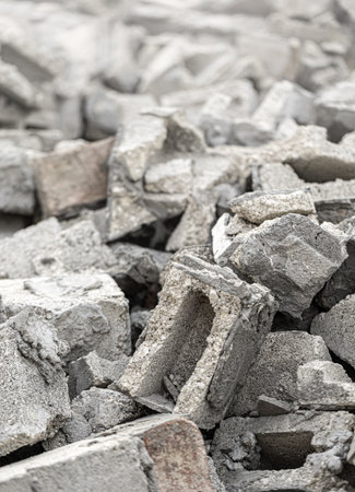 Gray concrete and brick rubble debris creating a large pile after building demolition