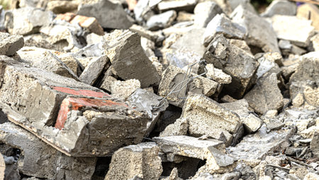 Close-up of broken concrete and brick rubble, highlighting the rough textures and debris of a demolished structureの写真素材