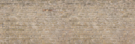 Seamless texture of an old beige brick wall, perfect for backgrounds and architectural visualizationの写真素材