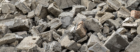 Gray concrete and brick rubble forms a textured background, suggesting demolition, construction, or...