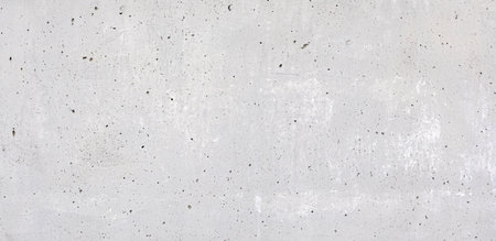 Close-up view of a gray concrete wall revealing its fine surface details, suitable as a background textureの写真素材