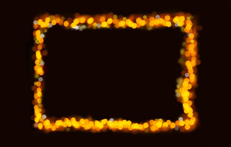 Golden bokeh lights form a festive, glowing frame against a dark background, perfect for holiday or celebratory designsの写真素材