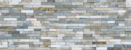 Decorative stone cladding forms a textured wall, ideal for backgrounds and design projects