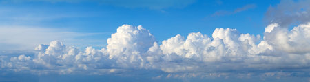 Blue sky showing white cumulus clouds creating a natural panoramic cloudscape
