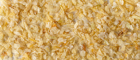 Dried onion flakes and white crystalline seasonings creating a uniform textured background