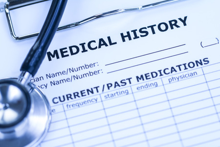 Medical History and Black Stethoscope in Blue White-balanceの写真素材
