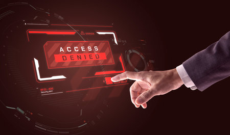 Right hand of a businessman touching a button while security warning alert sign of access denied...