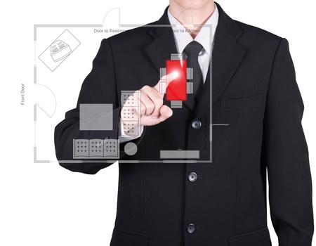 businessman press to floor plan on red button, isolatedの写真素材