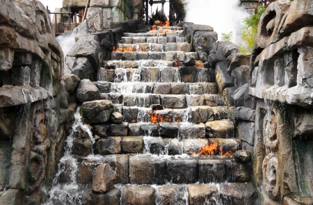 adventure on the rock ladder with waterfall & fireの写真素材