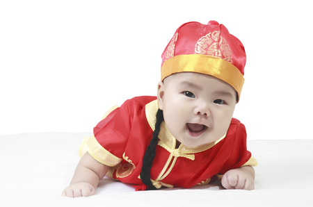 cheerful babies wearing Chinese New Year suit in studioの写真素材