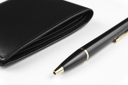 black wallet and pen on whiteの写真素材