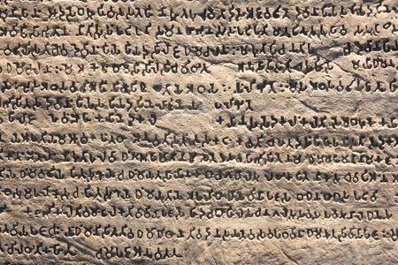 abstract old stone inscription wall at the archaeological or historic site for interior and exterior architecture or backgroundの写真素材