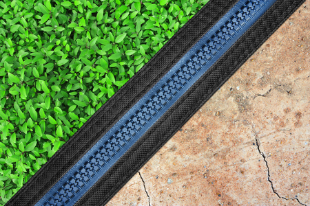 green grass plant with dry soil and zipper, the difference between fertility or abundant and drought for environmental conservationの写真素材