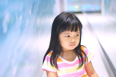 Asian children cute or kid girl upset or angry and sad feel with touchy for buy toy in department storeの写真素材