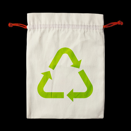 blank fabric or cloth flat bag cream or brown color with red or orange rope and green recycle symbol for nature conservation and environment with recycle reuse isolated on black included clipping pathの写真素材