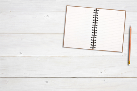 top view blank recycle notebook or diary for note or write with wood pencil on chic vintage white wood table or desk and space for your place object or textの写真素材