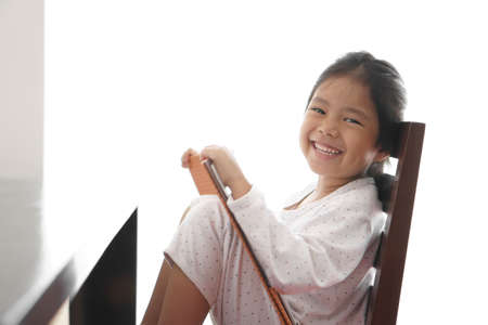 asian child cute or kid girl happy or student enjoy reading book and smile for learn to read with...