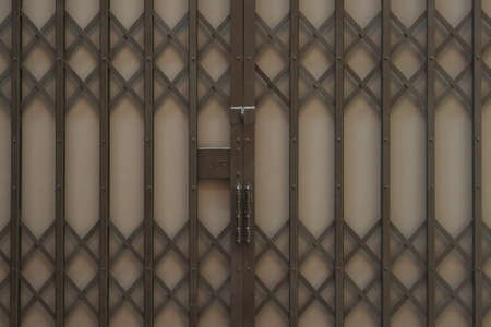 old brown or dark steel door stretch or empty retro wall with pin or knot and key lock for vintage...