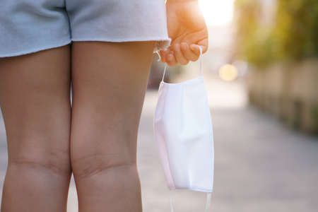 child stand back or kid girl holding white cloth mask for close mouth nose to protect influenza...