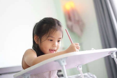 asian child new idea think or kid girl write or read and enjoy doing homework or happy learn and...