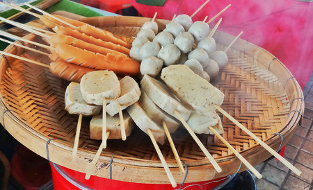 pork ball and  sausage on bamboo basket is popular Street foods.の写真素材