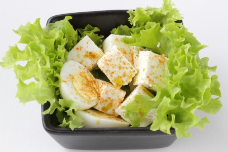 Cheese and hard boiled egg on a lettuce leafの写真素材