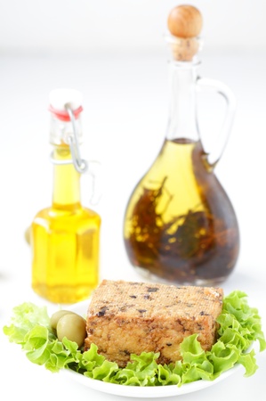 Tofu cheese with olives and oil bottleの写真素材