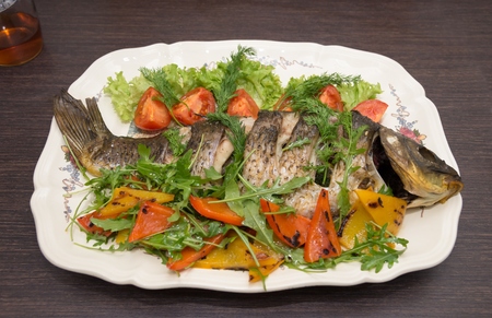 The baked carp with vegetables and spices