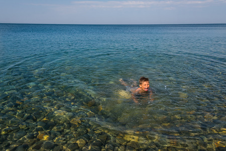 The child learns to swim at the seaの写真素材