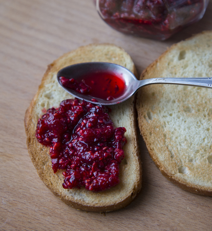 Tasty fresh white bread with raspberry jam