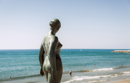 Sitges, Barcelona, Spain - September 29, 2016: Sculpture of a naked woman against Sitges town viewのeditorial素材