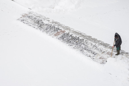 MOSCOW, RUSSIA - JANUARY 17, 2016: Worker in uniforms removes snow in the cityのeditorial素材