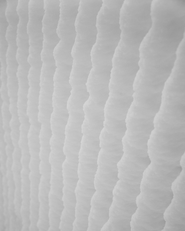 Winter background. Close up of fence wirecloth covered with snow, selective focusの写真素材