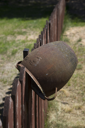 Traditional old clay pot on the wooden fenceの写真素材