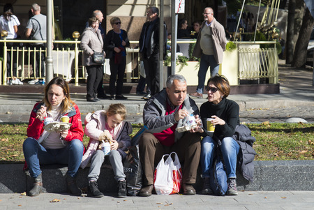LVIV / UKRAINE - OCTOBER 06, 2018: A group of people is having lunch outside. Liberty Avenue, Lvivのeditorial素材