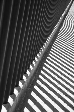 The shadow of the fence on the roadの写真素材