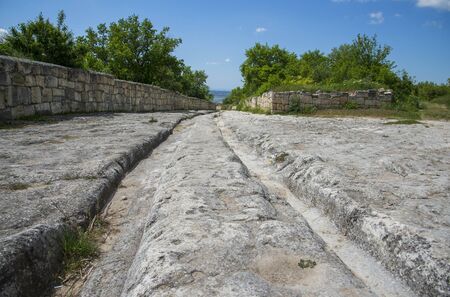 Ancient stony road through Chufut-Kale, medieval cave settlement in Crimeaの写真素材