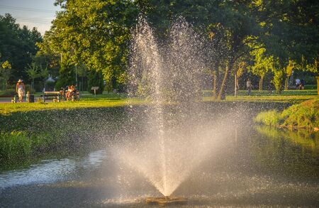 Beautiful park with fountain in the pond. Reda, Polandの写真素材