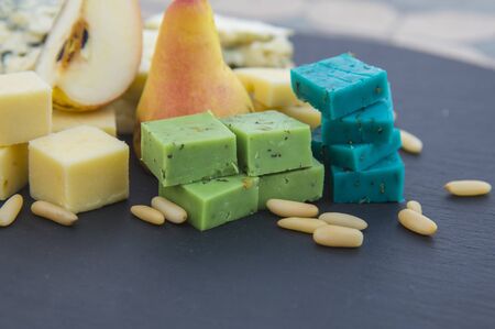 Various types of cheese, pear and pine nuts. Space for textの写真素材