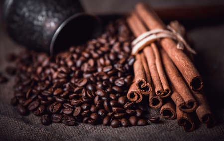 Coffee beans and cinnamon sticks, selective focusの写真素材