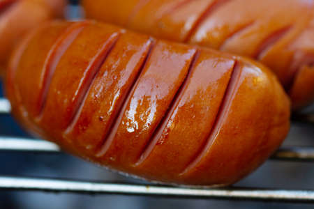 Grilled sausages on a barbecue grill close-up.の写真素材
