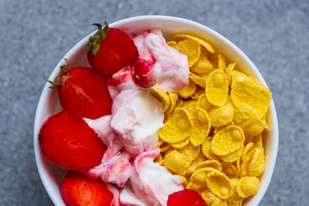 Ripe strawberries, yogurt and cornflakes. Healthy breakfast conceptの写真素材