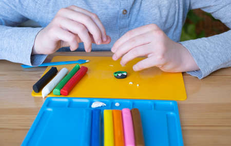 Children's hands during modeling from plasticineの写真素材