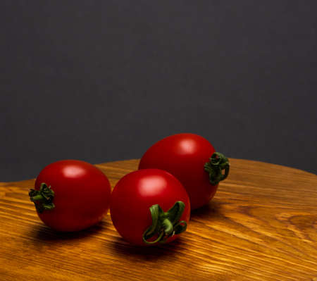 Fresh red tomatoes on an wooden tabletopの写真素材