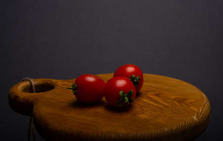 Fresh red tomatoes on an wooden tabletopの写真素材