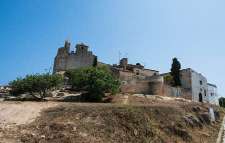 Calafell, Tarragona, Spain - July 31, 2019: Medieval stone castle on the rock in Calafell townのeditorial素材