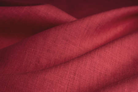 Natural linen fabric texture. Textured red fabric background. Macro with shallow dofの写真素材